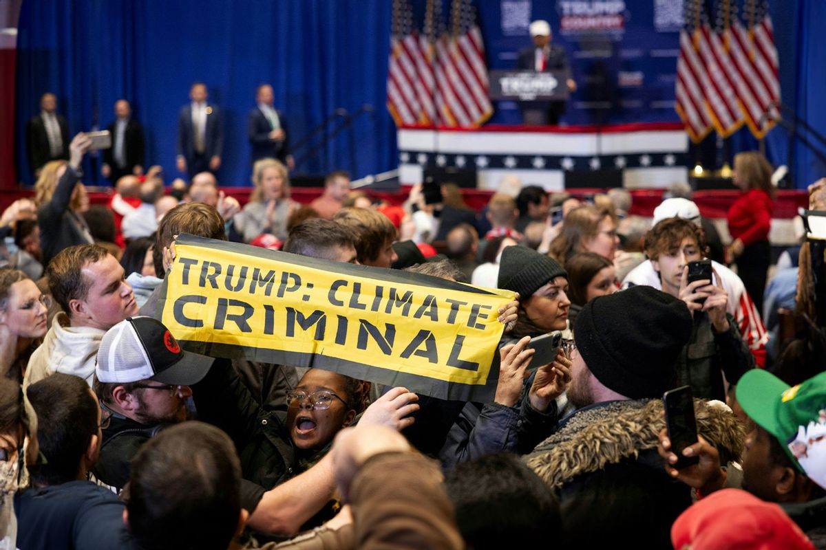 Climate protesters interrupt former US president and Republican presidential hopeful Donald Trump as he speaks at a "commit to caucus rally" in Indianola, Iowa, on January 14, 2024. (CHRISTIAN MONTERROSA/AFP via Getty Images)