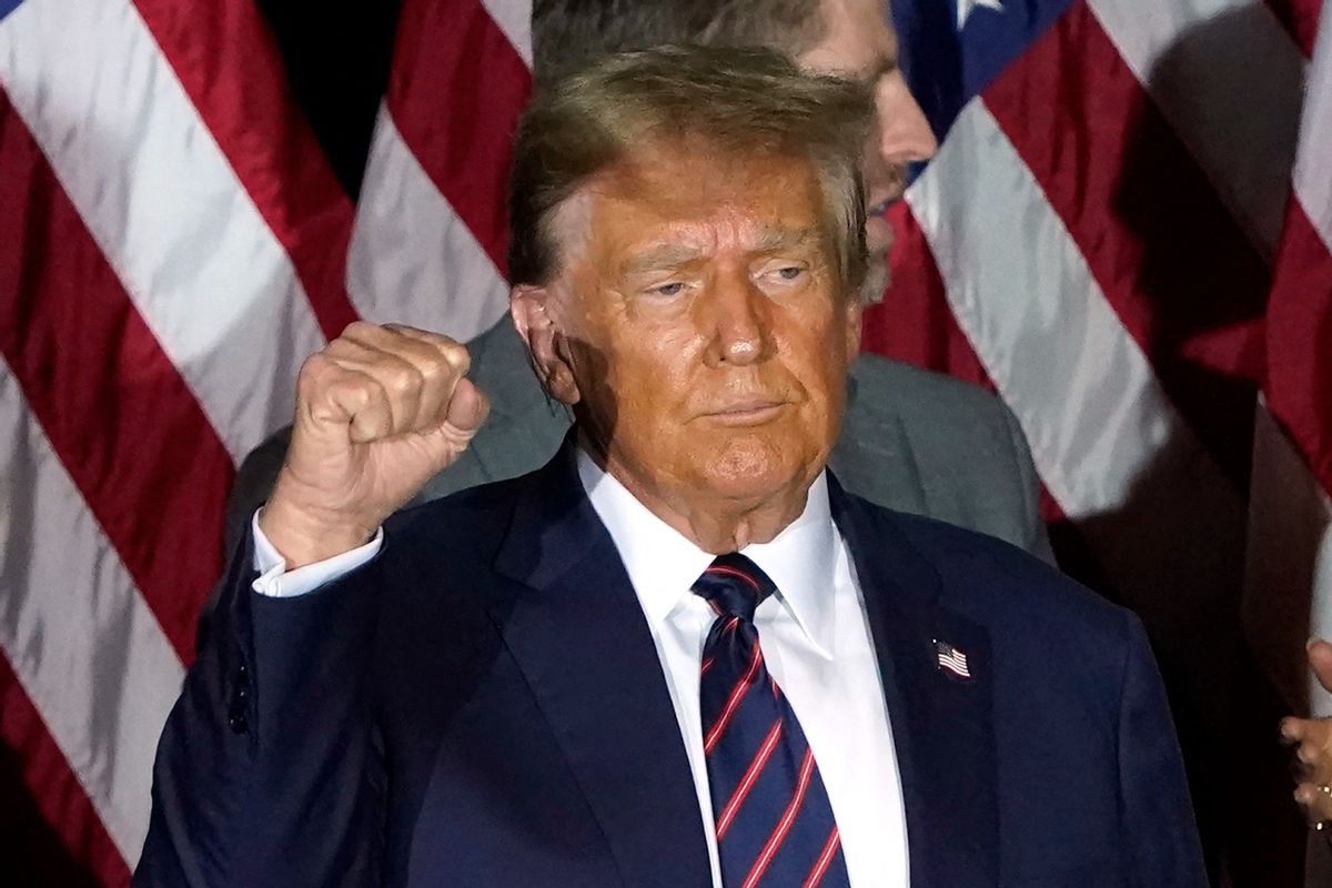 Republican presidential hopeful and former US President Donald Trump holds up his fist during an Election Night Party in Nashua, New Hampshire, on January 23, 2024.  (TIMOTHY A. CLARY/AFP via Getty Images)