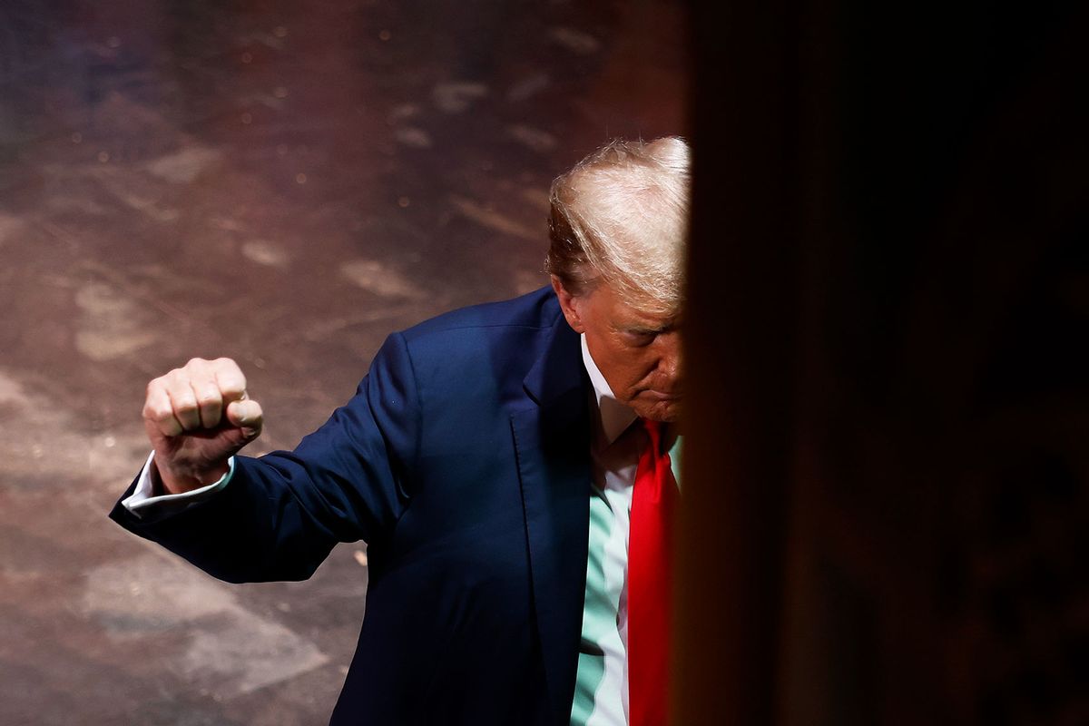 Republican presidential candidate and former President Donald Trump pumps his fist as he walks off the stage after a campaign rally at the Rochester Opera House on January 21, 2024 in Rochester, New Hampshire. (Chip Somodevilla/Getty Images)