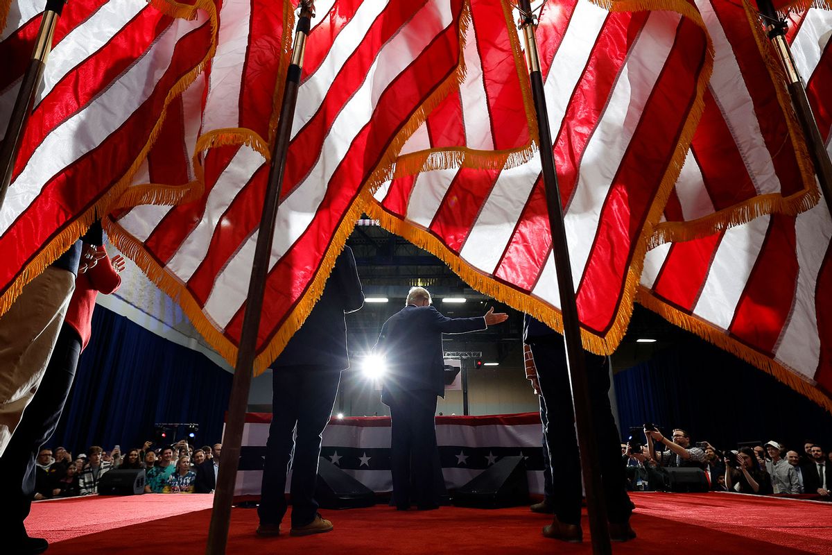 Flanked by his sons Eric Trump and Donald Trump Jr., Republican presidential candidate, former U.S. President Donald Trump speaks during his caucus night event at the Iowa Events Center on January 15, 2024 in Des Moines, Iowa. (Chip Somodevilla/Getty Images)