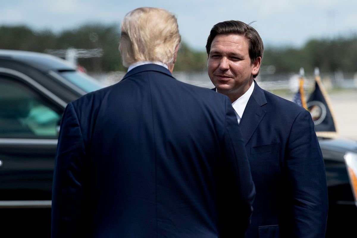 US President Donald Trump is greeted by Florida Governor Ron DeSantis at Southwest Florida International Airport October 16, 2020, in Fort Myers, Florida. (Photo by Brendan Smialowski / AFP) (Photo by  (BRENDAN SMIALOWSKI/AFP via Getty Images)
