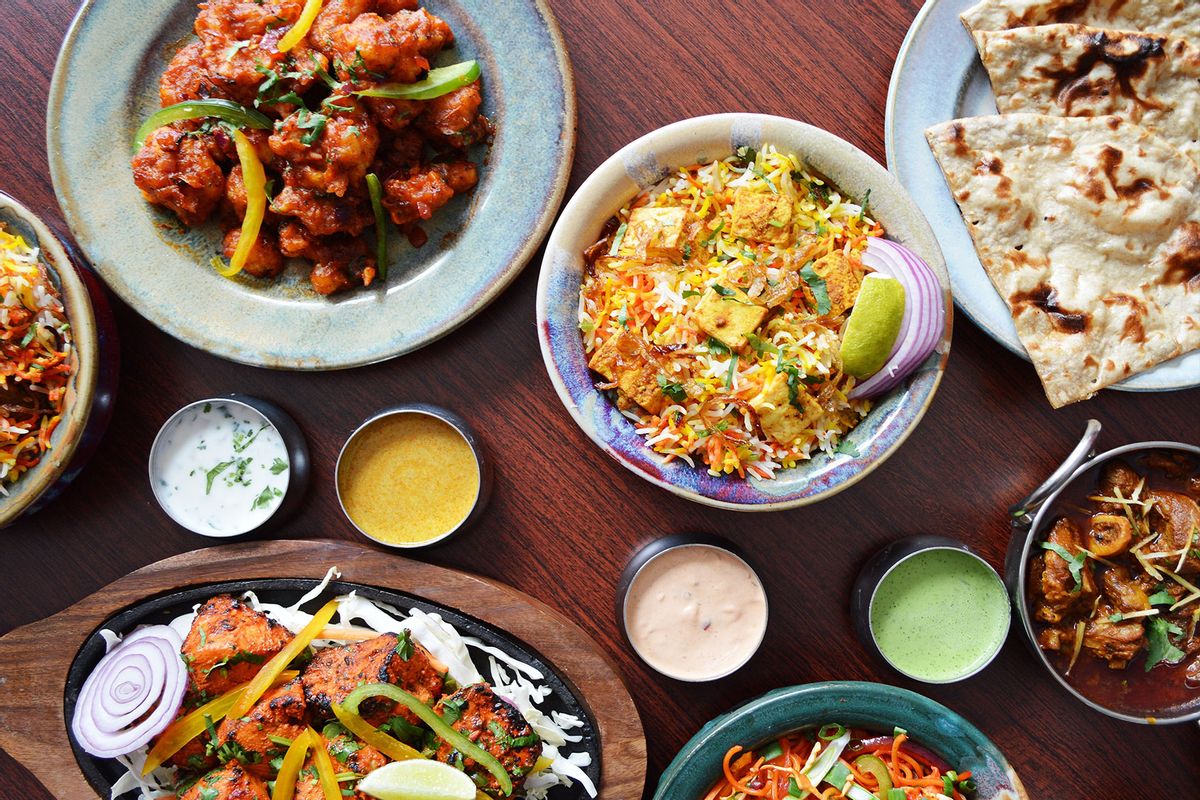A table set with Indian food , Nann, Biryani, Tandoori Chicken, Gobi Manchurian, Mutton Curry and sauces. (Getty Images/Chanda Hopkins)