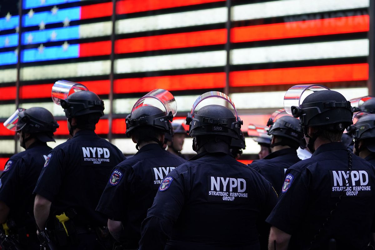NYPD police officers watch demonstrators in Times Square on June 1, 2020, during a "Black Lives Matter" protest. (TIMOTHY A. CLARY/AFP via Getty Images)