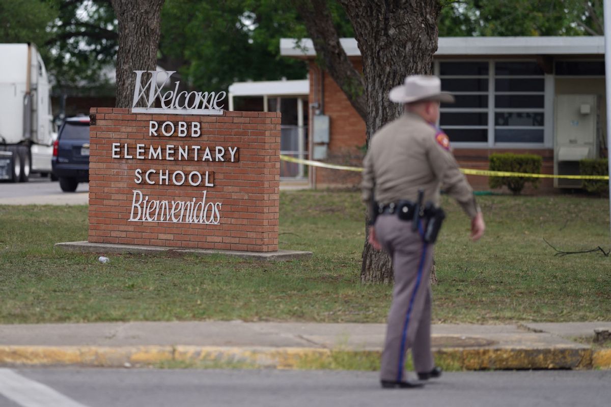 An officer walks outside of Robb Elementary School in Uvalde, Texas, on May 24, 2022. (ALLISON DINNER/AFP via Getty Images)