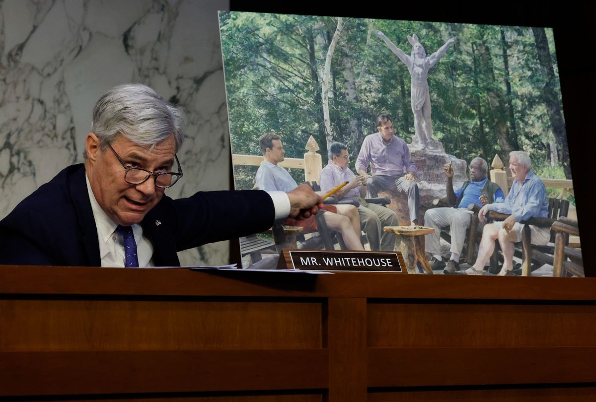 Senate Judiciary Committee member Sen. Sheldon Whitehouse (D-RI) displays a copy of a painting featuring Supreme Court Associate Justice Clarence Thomas alongside other conservative leaders during a hearing on Supreme Court ethics reform in the Hart Senate Office Building on Capitol Hill on May 02, 2023 in Washington, DC. The painting was commissioned by billionaire Texas Republican real estate developer Harlan Crow, who, according to a recent ProPublica investigation, invited Thomas on many luxury vacations over a number of years. (Chip Somodevilla/Getty Images)