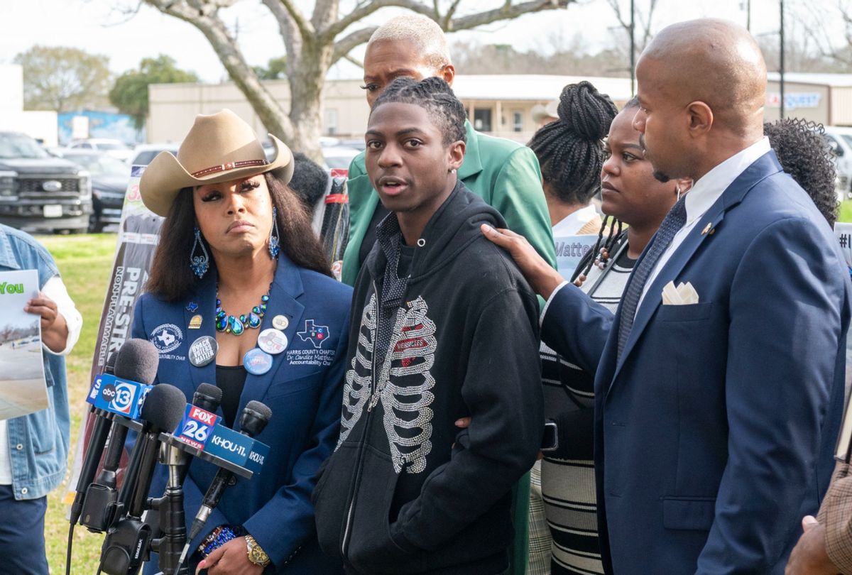 State Rep. Ron Reynolds (right) with Darryl George (center) makes comments before a hearing regarding George's punishment for violating school dress code policy because of his hair style, Feb. 22, 2024 at the Chambers County Courthouse.  (Kirk Sides/Houston Chronicle via Getty Images)