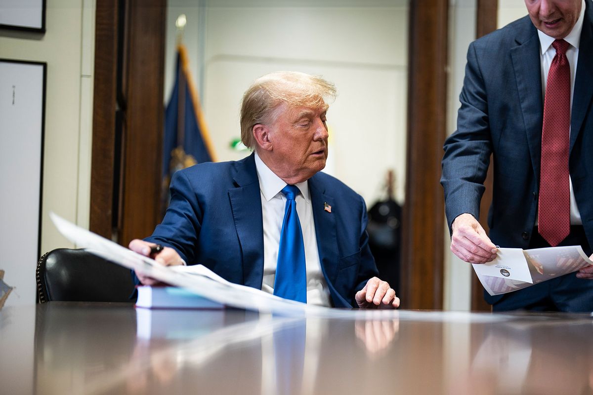 Former President Donald Trump signs autographs with Secretary of State David Scanlan after signing papers to be on the 2024 Republican presidential primary ballot at the New Hampshire Statehouse on Monday, Oct. 23, 2023, in Concord, NH. (Jabin Botsford/The Washington Post via Getty Images)