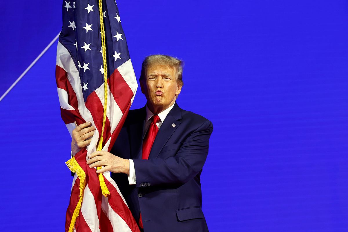 Donald Trump hugs an American flag as he arrives at the Conservative Political Action Conference (CPAC on February 24, 2024 in National Harbor, Maryland. (Anna Moneymaker/Getty Images)