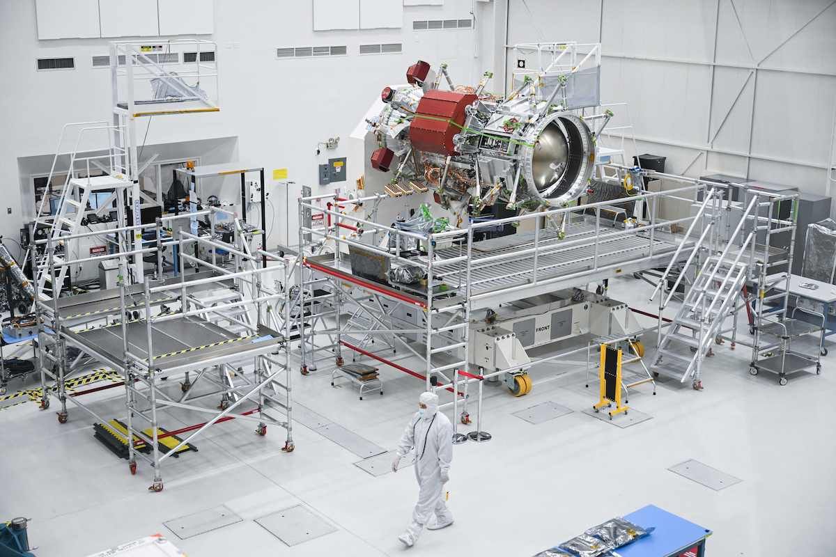 A worker wears a clean room suit as they walk past a propulsion component of the Europa Clipper spacecraft while it is prepared for a mission to Jupiter's moon Europa inside a clean room at NASA's Jet Propulsion Laboratory (JPL) in Pasadena, California on April 11, 2023. - In October 2024, NASA will launch the Europa Clipper spacecraft that will study Jupiter's moon and its underground oceans. (Photo by Patrick T. Fallon / AFP) (Photo by PATRICK T. FALLON/AFP via Getty Images) (PATRICK T. FALLON / Contributor (Getty Images))
