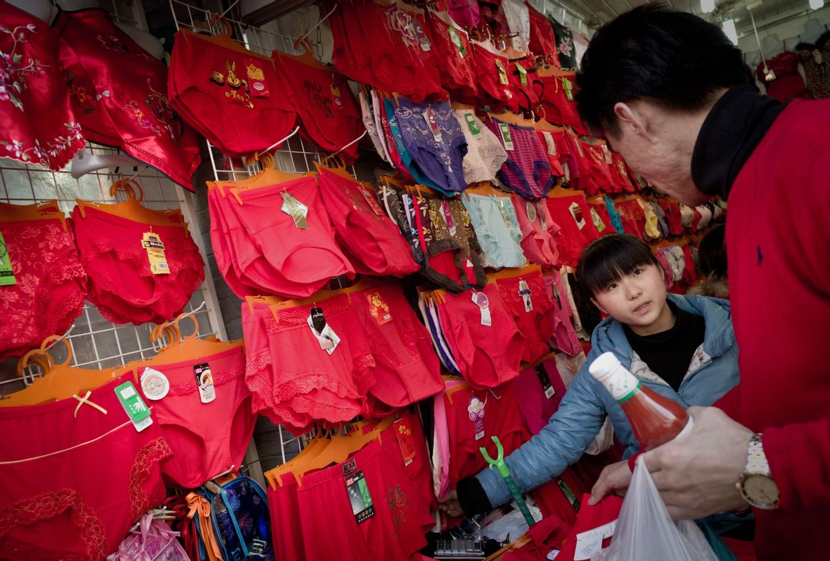 A Chinese chooses red underwear displayed in a shop on the first day of the Chinese Lunar New Year in Shanghai on February 3, 2011 (PHILIPPE LOPEZ/AFP via Getty Images)