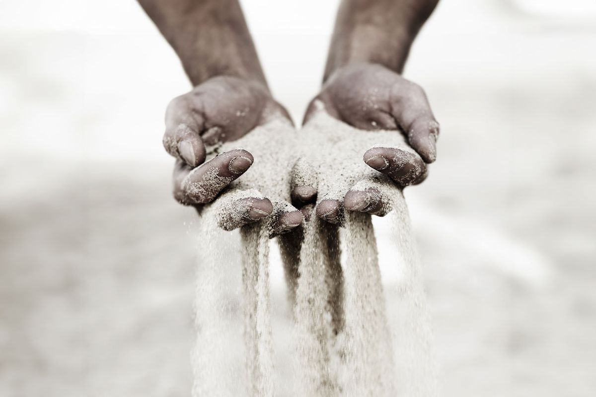 Sand slipping through fingers (Getty Images/PeopleImages)