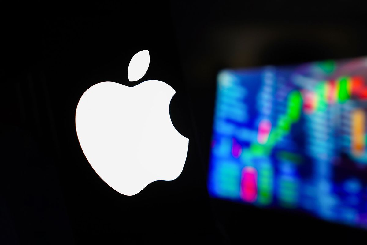 The Apple Inc. logo is displayed on a smartphone screen, with a graphic representation of the stock market in the background. (Photo Illustration by Rafael Henrique/SOPA Images/LightRocket via Getty Images)