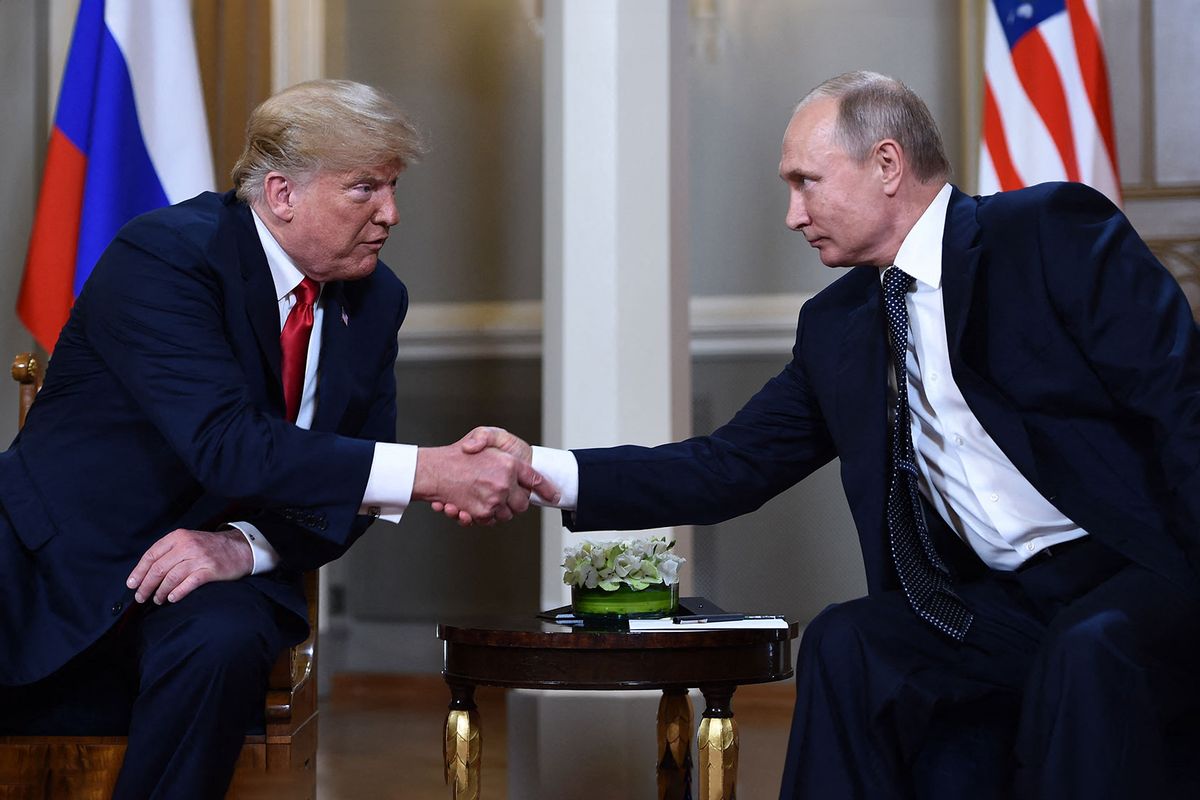 Russian President Vladimir Putin (R) and US President Donald Trump shake hands before a meeting in Helsinki, on July 16, 2018. (BRENDAN SMIALOWSKI/AFP via Getty Images)