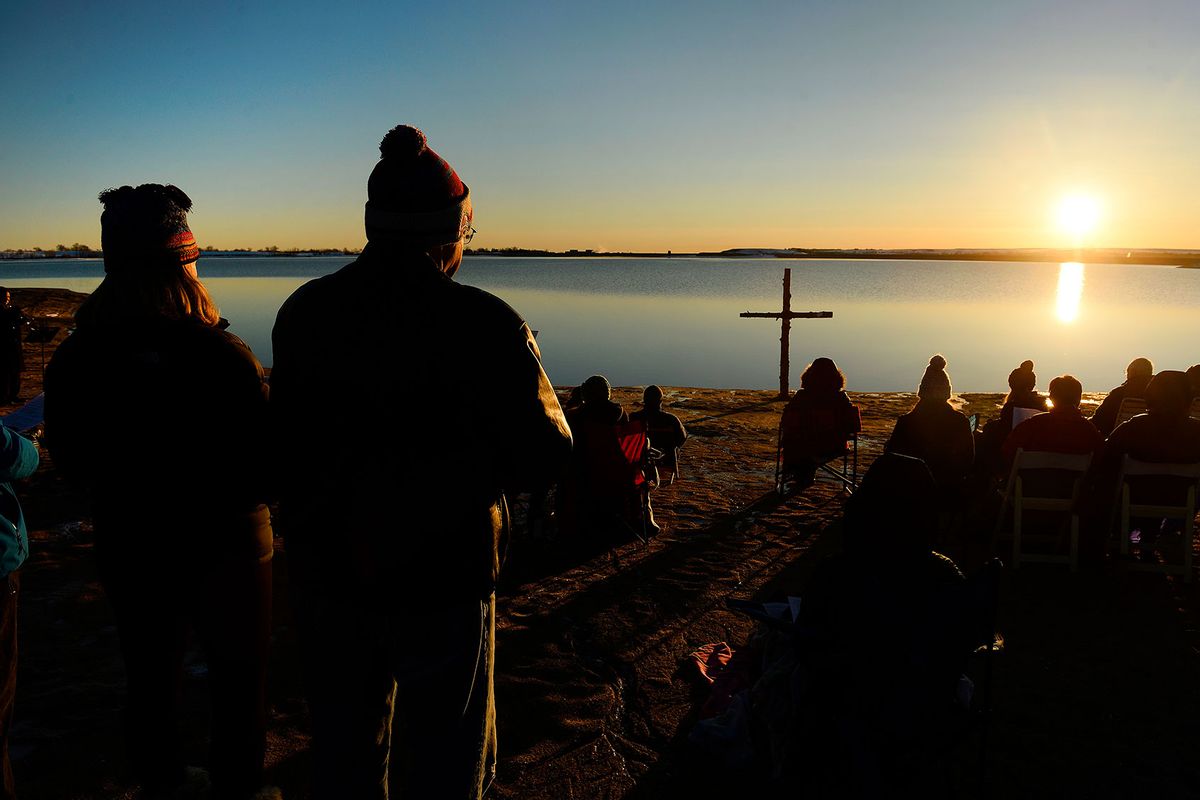 Parishioners, who brought plenty of warm clothes and blankets, listen to the sermon during Easter sunrise celebration service on the shores of Boulder Reservoir on March 27, 2016 in Boulder, Colorado. (Helen H. Richardson/The Denver Post via Getty Images)