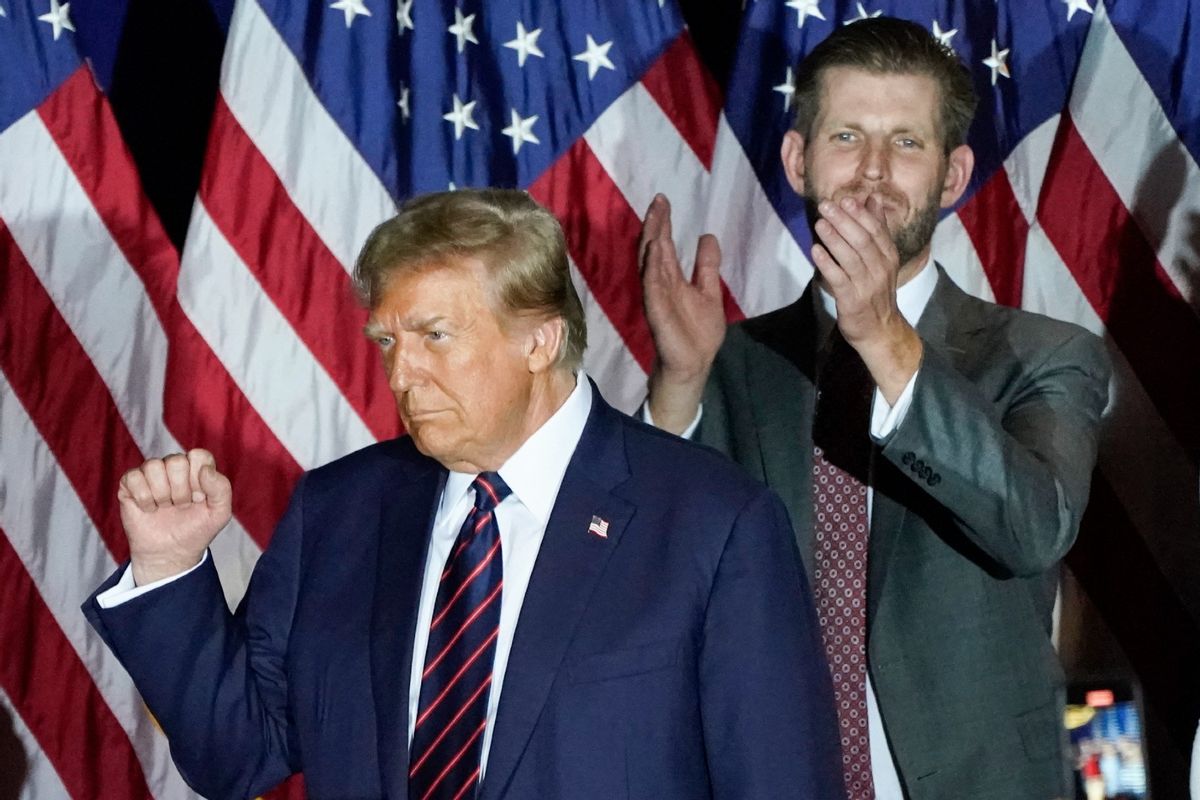 Republican presidential hopeful and former US President Donald Trump gestures next to son Eric Trump during an Election Night Party in Nashua, New Hampshire, on January 23, 2024.  (TIMOTHY A. CLARY/AFP via Getty Images)