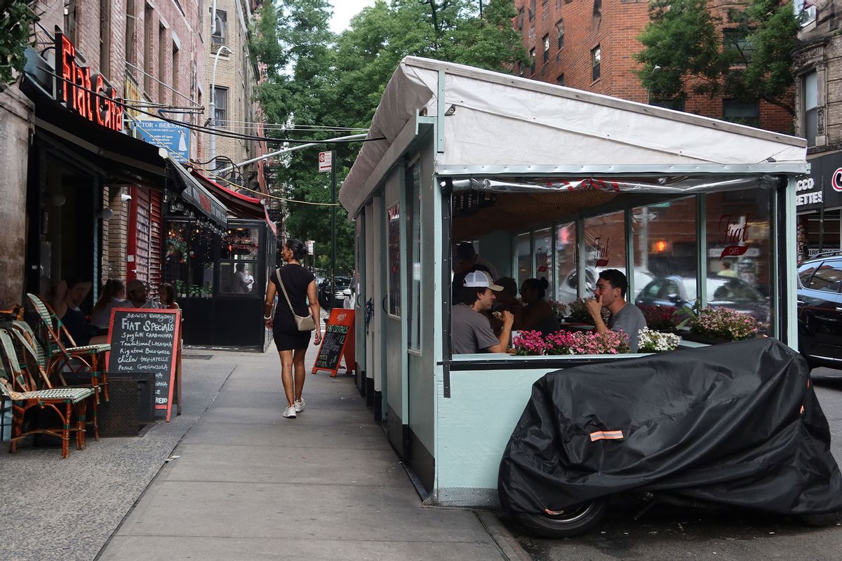 People eat in a restaurant sidewalk shed on Mott Street in Little Italy in New York City. (Gary Hershorn/Getty Images)