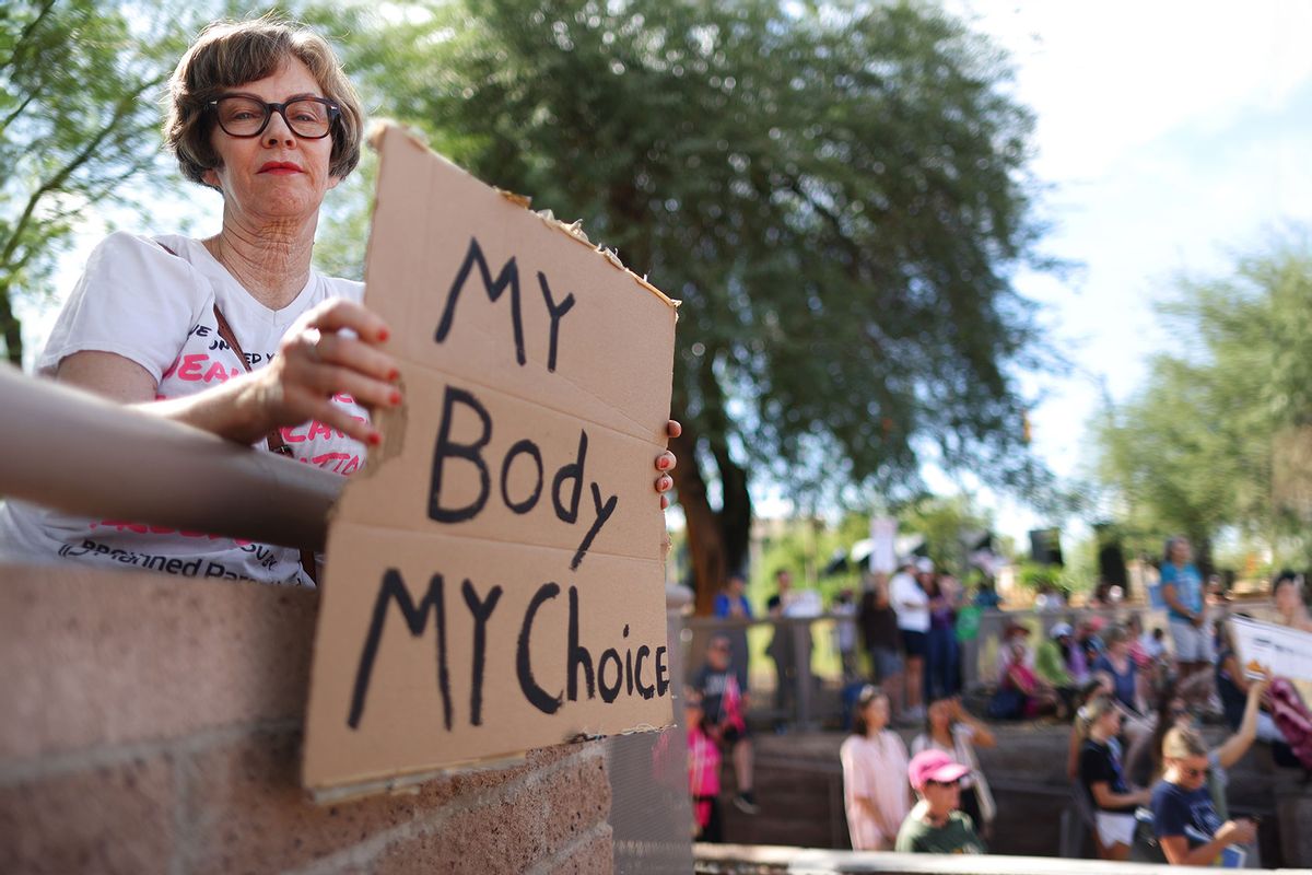 A protestor holds a sign reading 'My Body My Choice' at a Women's March rally outside the Arizona State Capitol on October 8, 2022 in Phoenix, Arizona. (Mario Tama/Getty Images)