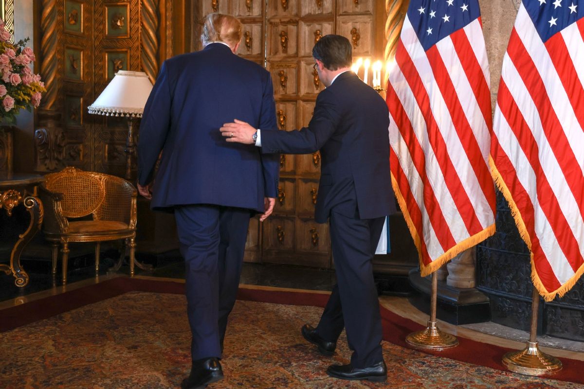 Republican presidential candidate former President Donald Trump and Speaker of the House Mike Johnson (R-LA) exit together after holding a press conference at Trump's Mar-a-Lago estate on April 12, 2024, in Palm Beach, Florida. (Joe Raedle/Getty Images)