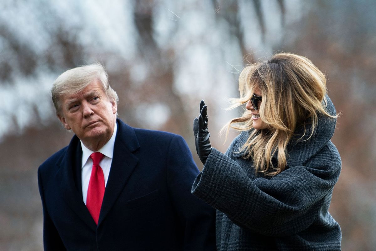 US President Donald Trump and First Lady Melania Trump walk from Marine One as they return to the White House on December 31, 2020, in Washington, DC. (BRENDAN SMIALOWSKI/AFP via Getty Images)