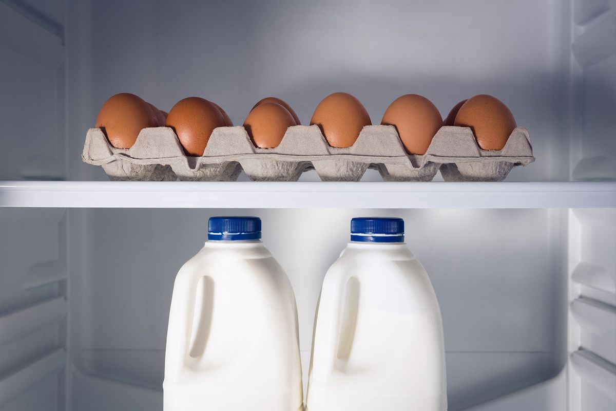 Egg carton and milk bottles in refrigerator (Getty Images/Wavebreakmedia)