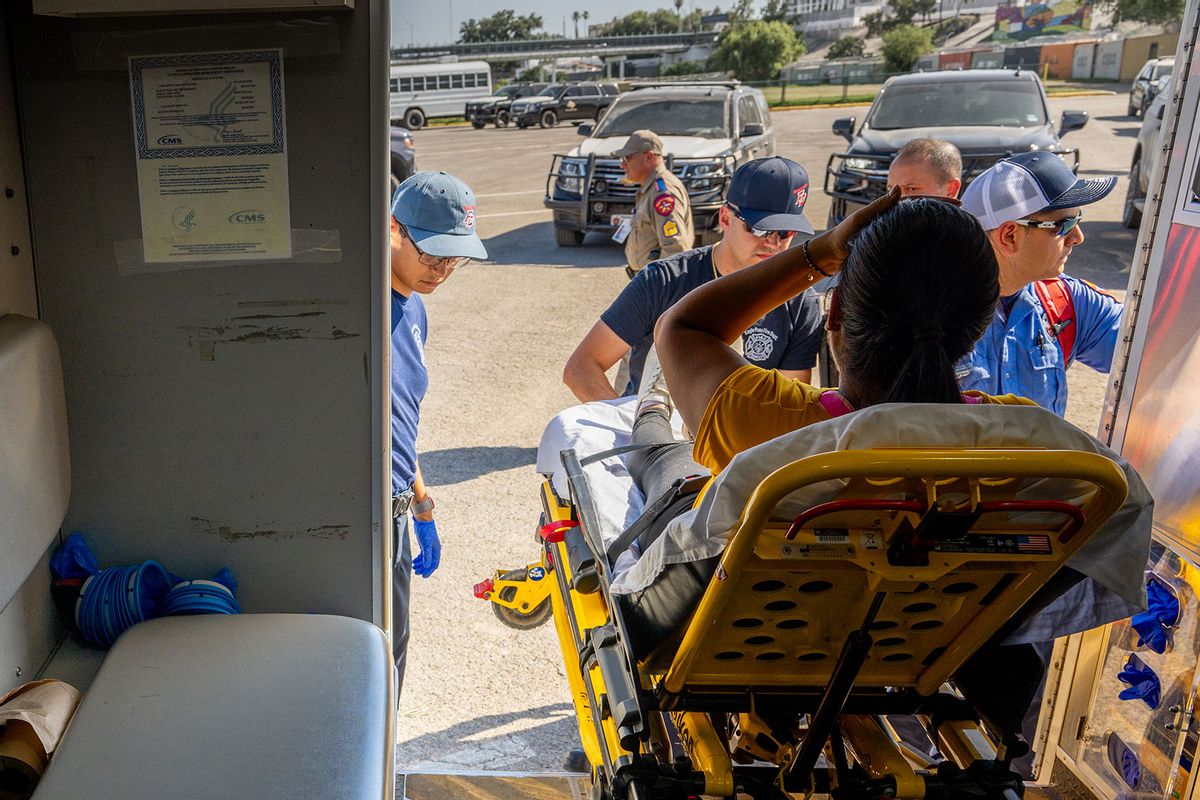 Eagle Pass Station 1 emergency medical technicians respond to a pregnant woman suffering from dehydration on July 19, 2023 in Eagle Pass, Texas. (Brandon Bell/Getty Images)