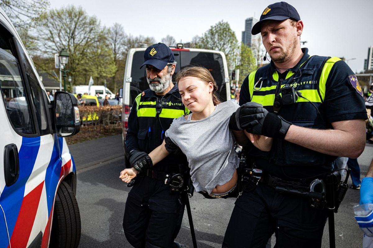 Police detain Swedish climate activist Greta Thunberg (C) during a climate march against fossil subsidies near the highway A12 in the Hague, on April 6, 2024.  (RAMON VAN FLYMEN/ANP/AFP via Getty Images)