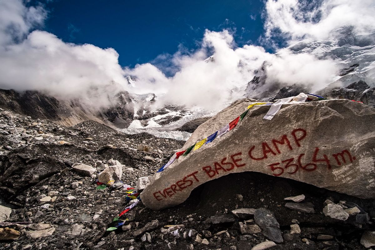 Everest Base Camp 5364 m, written on a big rock on Khumbu glacier, Mt. Everest behind covered by monsoon clouds. (Frank Bienewald/LightRocket via Getty Images)