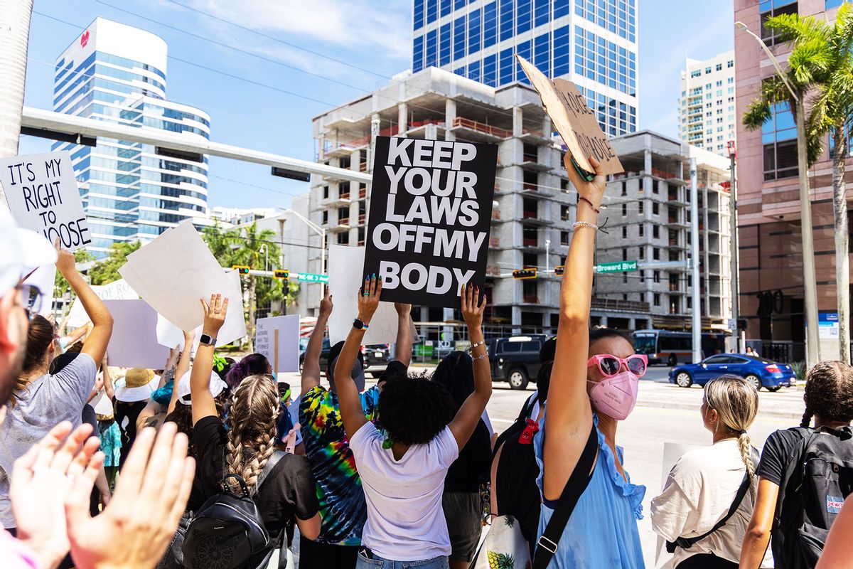 An abortion rights activist holds a sign at a protest in support of abortion access, March To Roe The Vote And Send A Message To Florida Politicians That Abortion Access Must Be Protected And Defended, on July 13, 2022 in Fort Lauderdale, Florida. (John Parra/Getty Images for MoveOn)