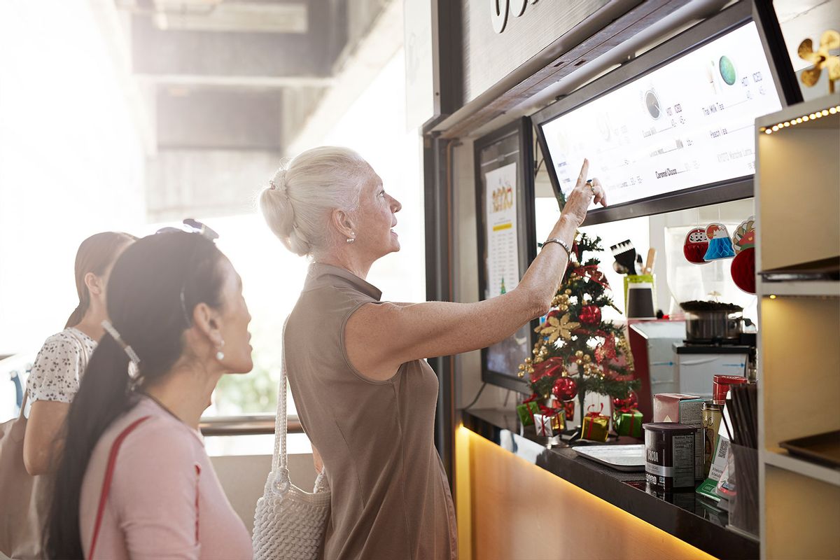 Senior woman ordering at fast food restaurant (Getty Images/Klaus Vedfelt)
