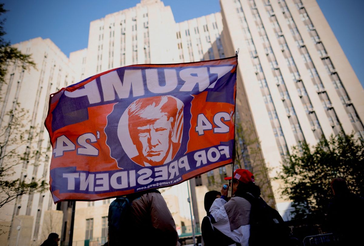 A supporter of former Donald Trump waves a Trump-themed flag outside Manhattan Criminal Court as Trump attends his trial for allegedly covering up hush money payments, April 25, 2024. (Kena Betancur/AFP via Getty Images)