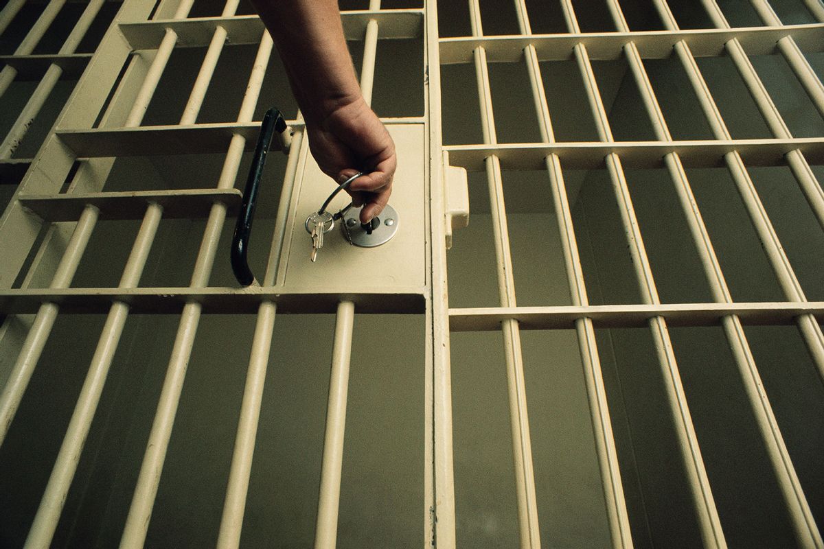 Unlocking Jail Cell Door (Getty Images/Charles O'Rear)