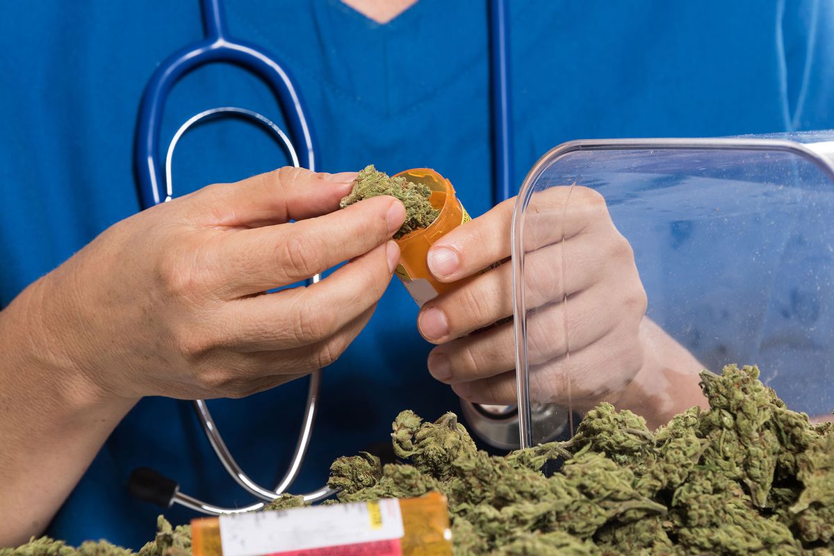 Doctor filling a prescription container with marijuana (Getty Images/Juanmonino)