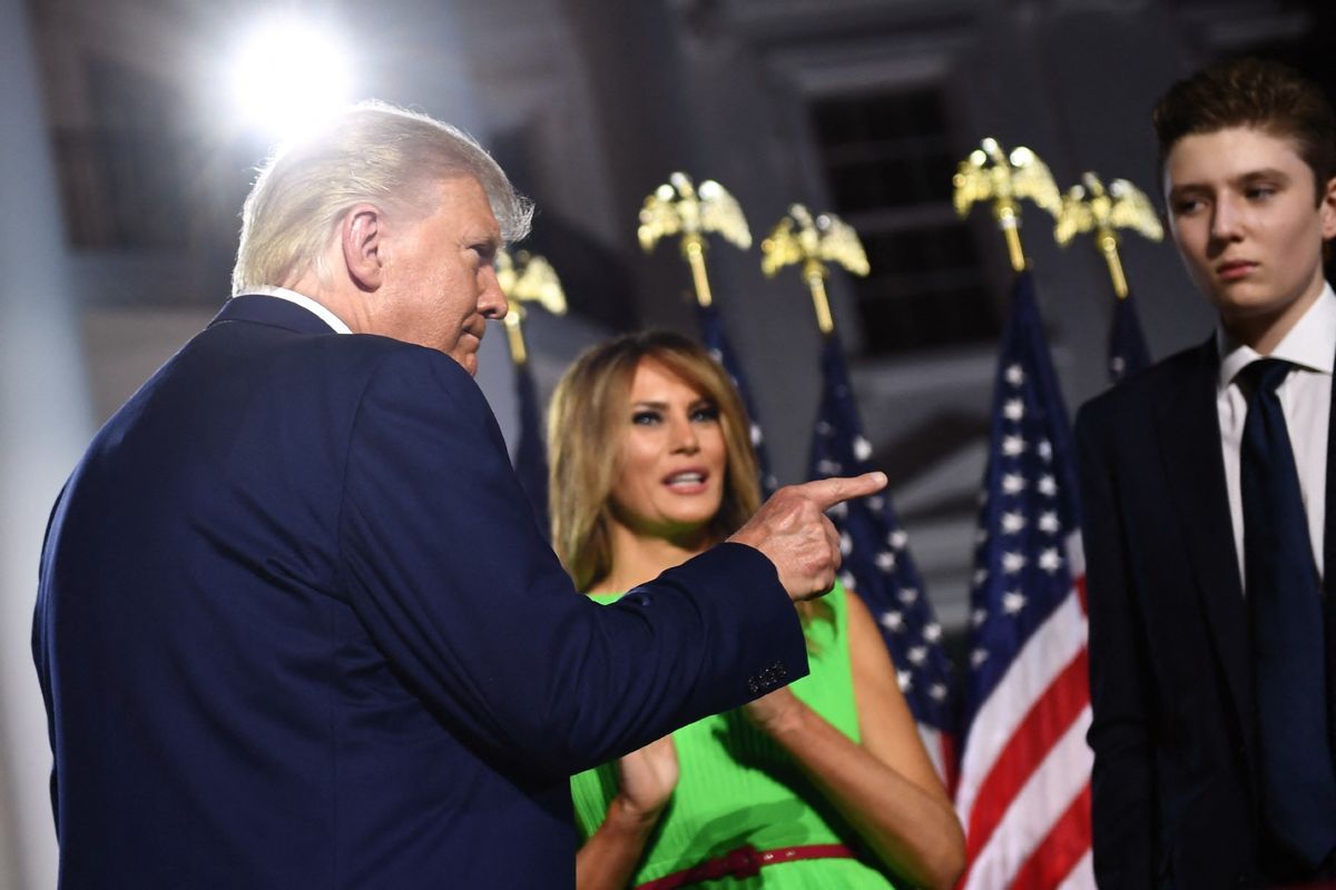 Former U.S. President Donald Trump (L) gestures, flanked by former First Lady Melania Trump and son Barron Trump, as they prepare to leave after he delivered his acceptance speech for the Republican Party nomination for reelection during the final day of the Republican National Convention at the South Lawn of the White House in Washington, DC on August 27, 2020.  (BRENDAN SMIALOWSKI/AFP via Getty Images)