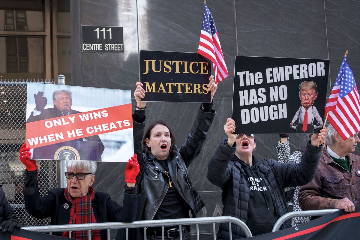Participants seen holding signs outside the New York Criminal Court. (Erik McGregor/LightRocket via Getty Images)