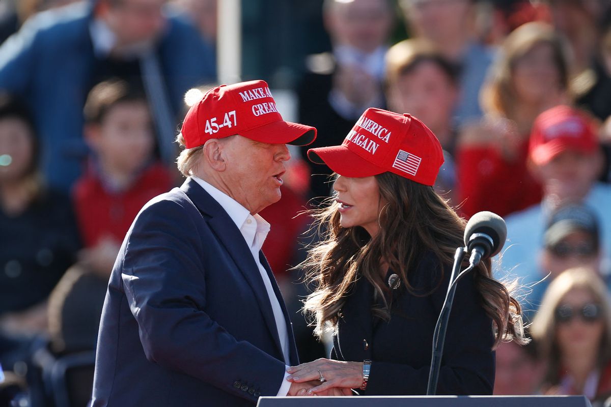 Former US President and Republican presidential candidate Donald Trump shakes hands with North Dakota Governor Kristi Noem during a Buckeye Values PAC Rally in Vandalia, Ohio, on March 16, 2024. (KAMIL KRZACZYNSKI/AFP via Getty Images)