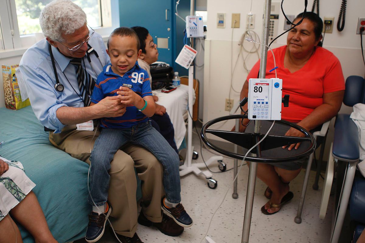 Dr. Paul Harmatz doing a general check-up on Joao Bueno (left), 6 years old, from Brazil, during his weekly enzyme replacement therapy with other children having different forms of MPS--Mucopolysaccharidosis--at Oakland Children's hospital in Oakland, Ca ((Photo By Liz Hafalia/The San Francisco Chronicle via Getty Images))