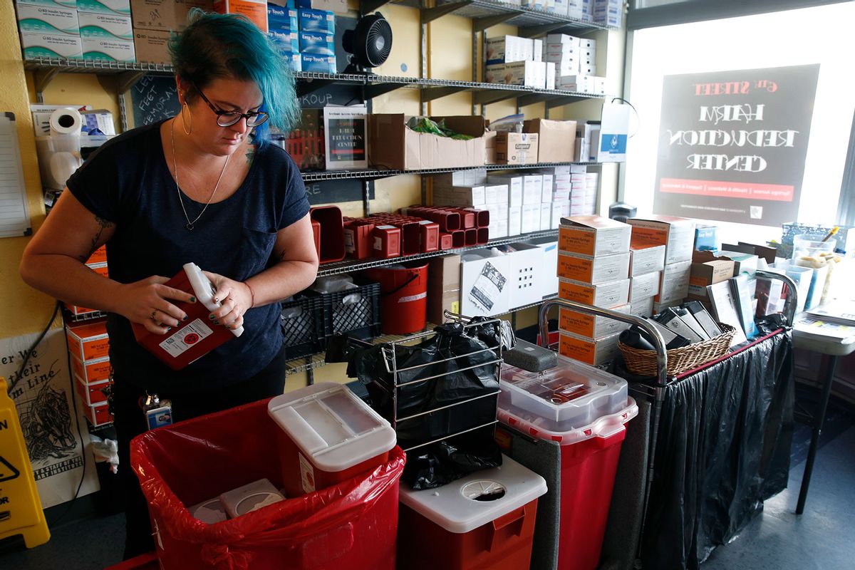 Manager of overdose prevention secures covers on returned full sharps containers at the 6th Street Harm Reduction Center operated by the SF AIDS Foundation in San Francisco, Calif. on Friday, June 2, 2017. (Paul Chinn/The San Francisco Chronicle via Getty Images)