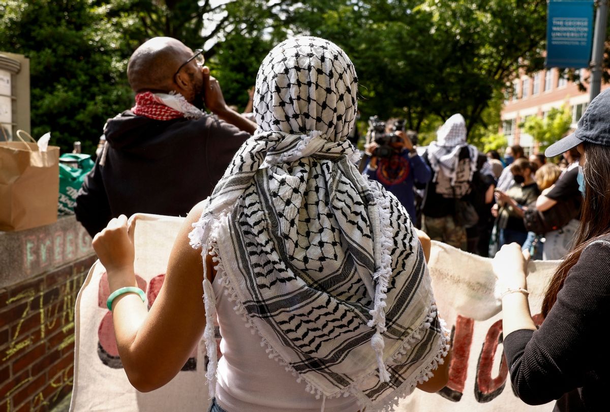 An activist wears a keffiyeh as they protest on the outskirts of an encampment demonstration at the University Yard at George Washington University on April 26, 2024 in Washington, DC ( Anna Moneymaker/Getty Images)