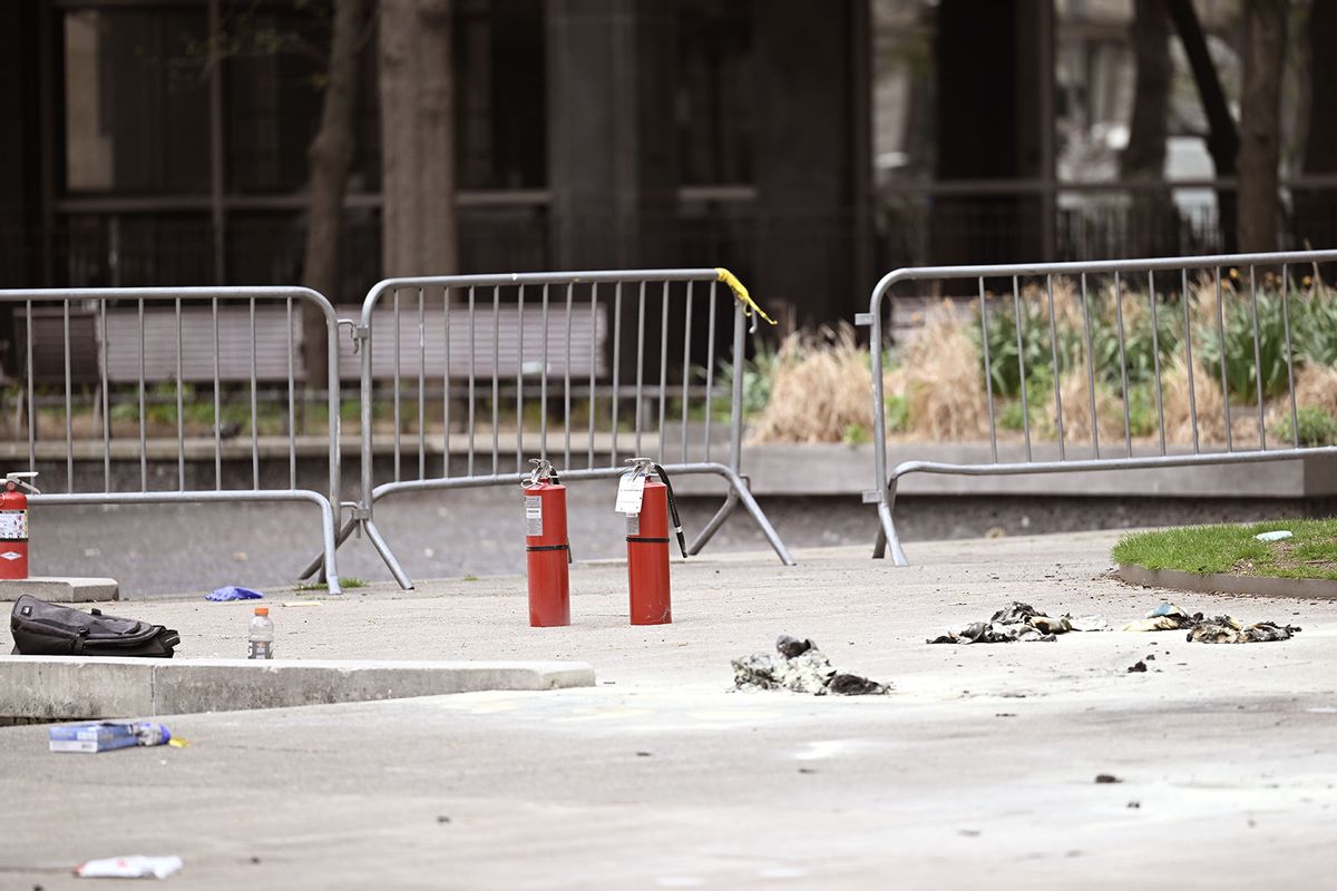 Fire extinguishers are seen at the scene as officials inspect the scene at the park across from Manhattan Criminal Court in New York City, after a man reportedly set himself on fire during the trial of US President Donald Trump, in New York,United States on April 19, 2024. (Fatih Aktas/Anadolu via Getty Images)