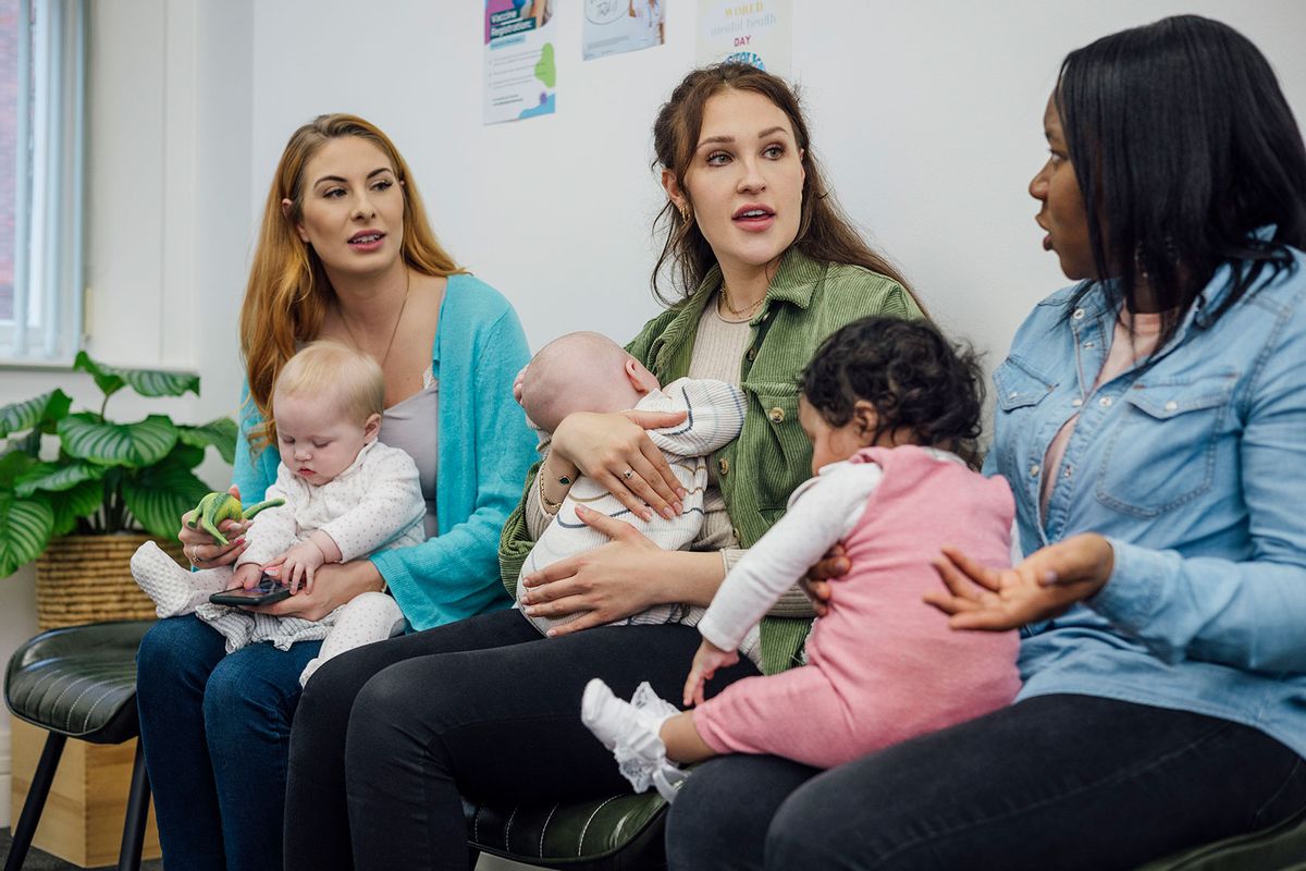 A shot of a group of women sitting together with their babies in the waiting room of a baby clinic (Getty Images/SolStock)