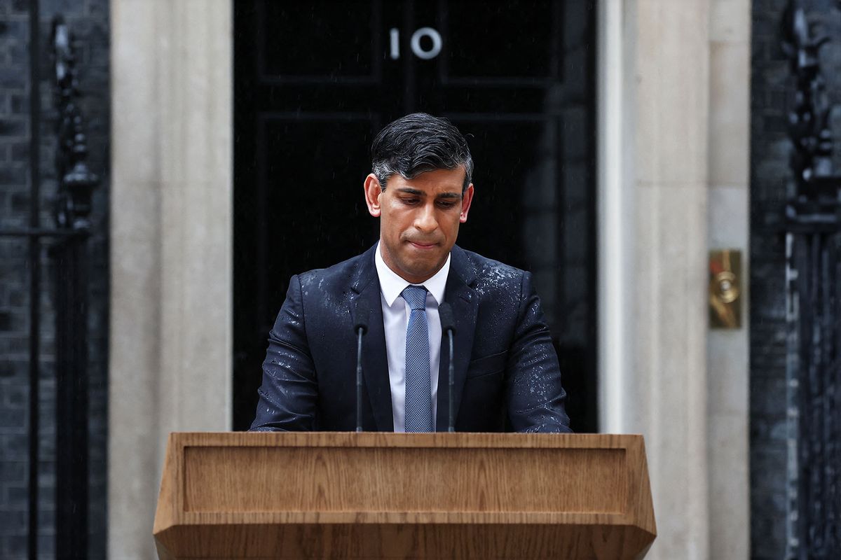 Britain's Prime Minister Rishi Sunak, soaked in rain, pauses as he delivers a speech to announce July 4 as the date of the UK's next general election, at 10 Downing Street in central London, on May 22, 2024. (HENRY NICHOLLS/AFP via Getty Images)