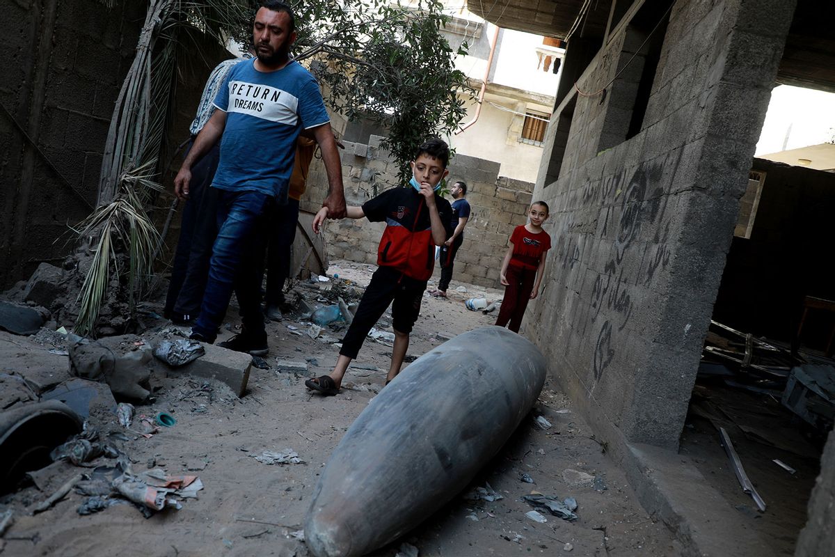 Palestinians look at an unexploded bomb dropped by an Israeli F-16 warplane on Gaza City's Rimal neighbourhood on May 18, 2021. (Majdi Fathi/NurPhoto via Getty Images)