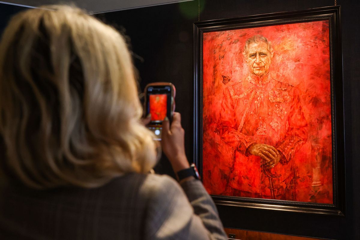 A woman takes photographs of King Charles' first official portrait painted by Jonathan Yeo on public display at Philip Mould Gallery in central London, Britain, May, 16, 2024. (Stringer/Anadolu via Getty Images)