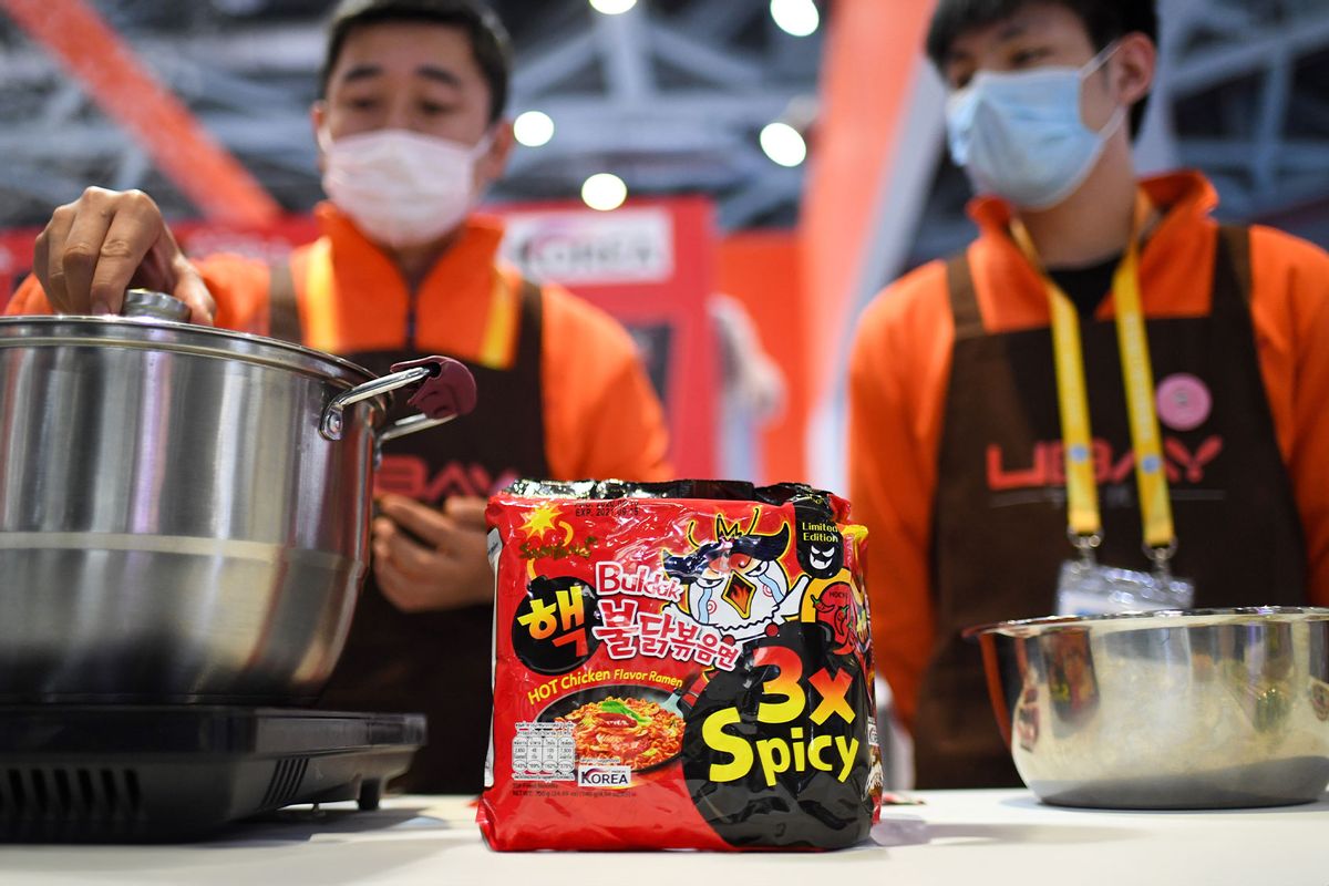 A staff member cooks turkey noodles at the booth of Samyang Foods Co., Ltd. at the Food and Agricultural Products exhibition area during the third China International Import Expo CIIE in Shanghai, east China, Nov. 5, 2020. (Xinhua/Chen Yehua via Getty Images)