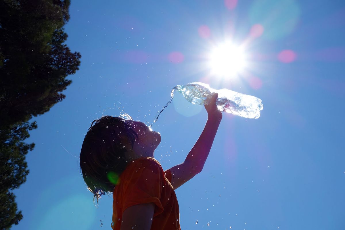 Child pouring water on himself on a hot day (Getty Images/AlesVeluscek)
