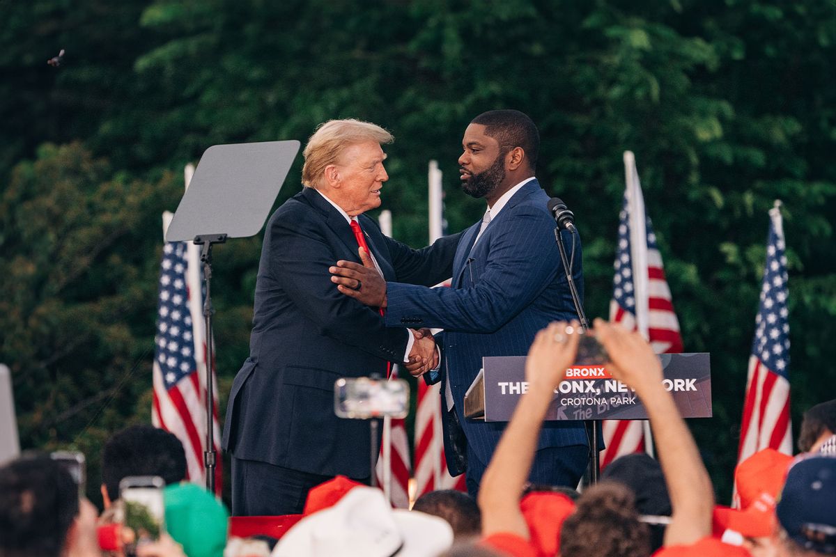 Former President Donald Trump greets Representative Byron Donalds, a Republican from Florida, during a campaign rally at Crotona Park in Bronx on May 23, 2024. (Jeenah Moon for The Washington Post via Getty Images)