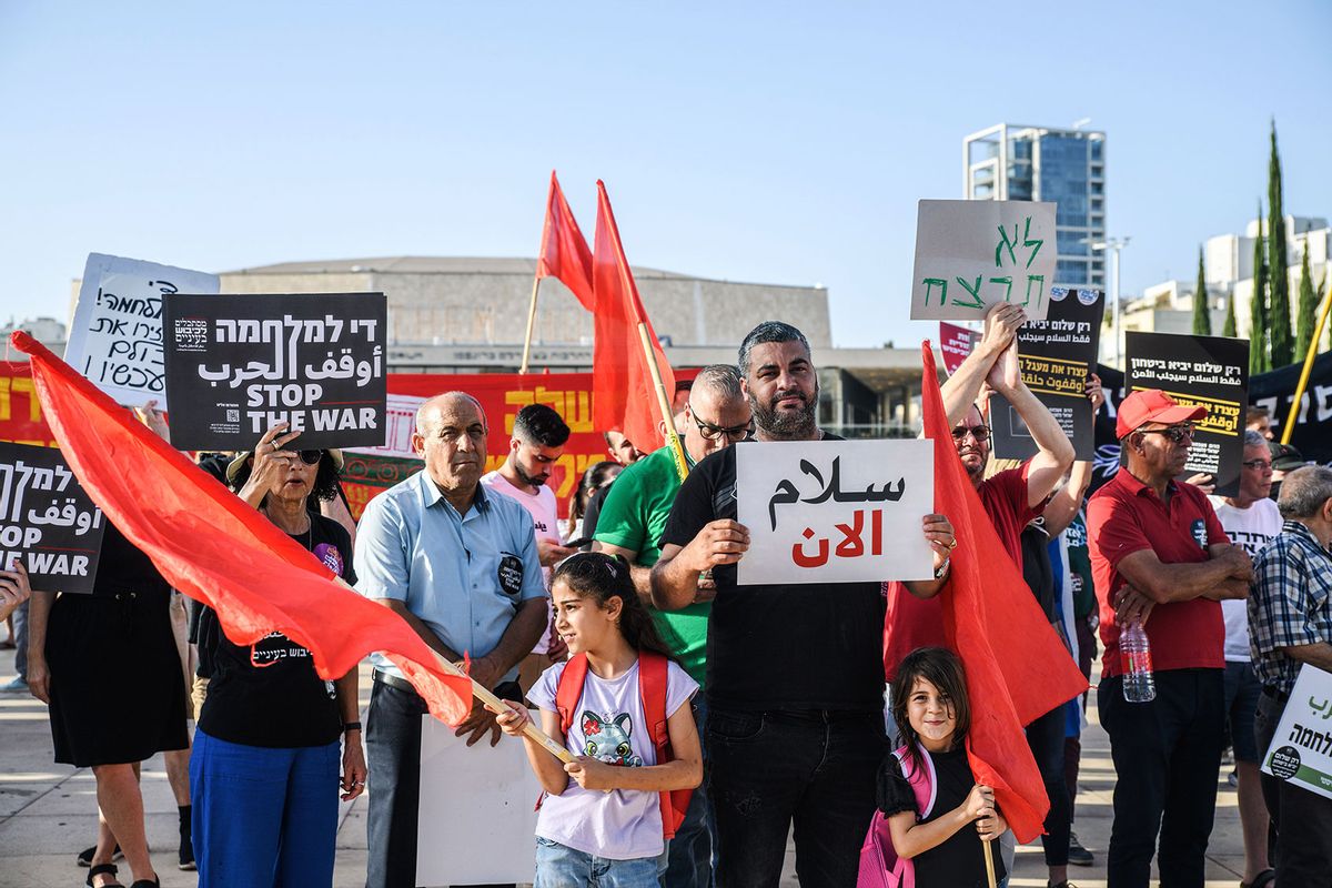 Israelis hold placards against the war in Arabic, Hebrew, and English during a demonstration on June 8, 2024. (Matan Golan/SOPA Images/LightRocket via Getty Images)