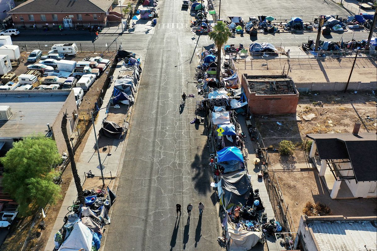 In an aerial view, people walk through a section of the 'The Zone', Phoenix's largest homeless encampment, amid the city's worst heat wave on record on July 26, 2023 in Phoenix, Arizona. (Mario Tama/Getty Images)