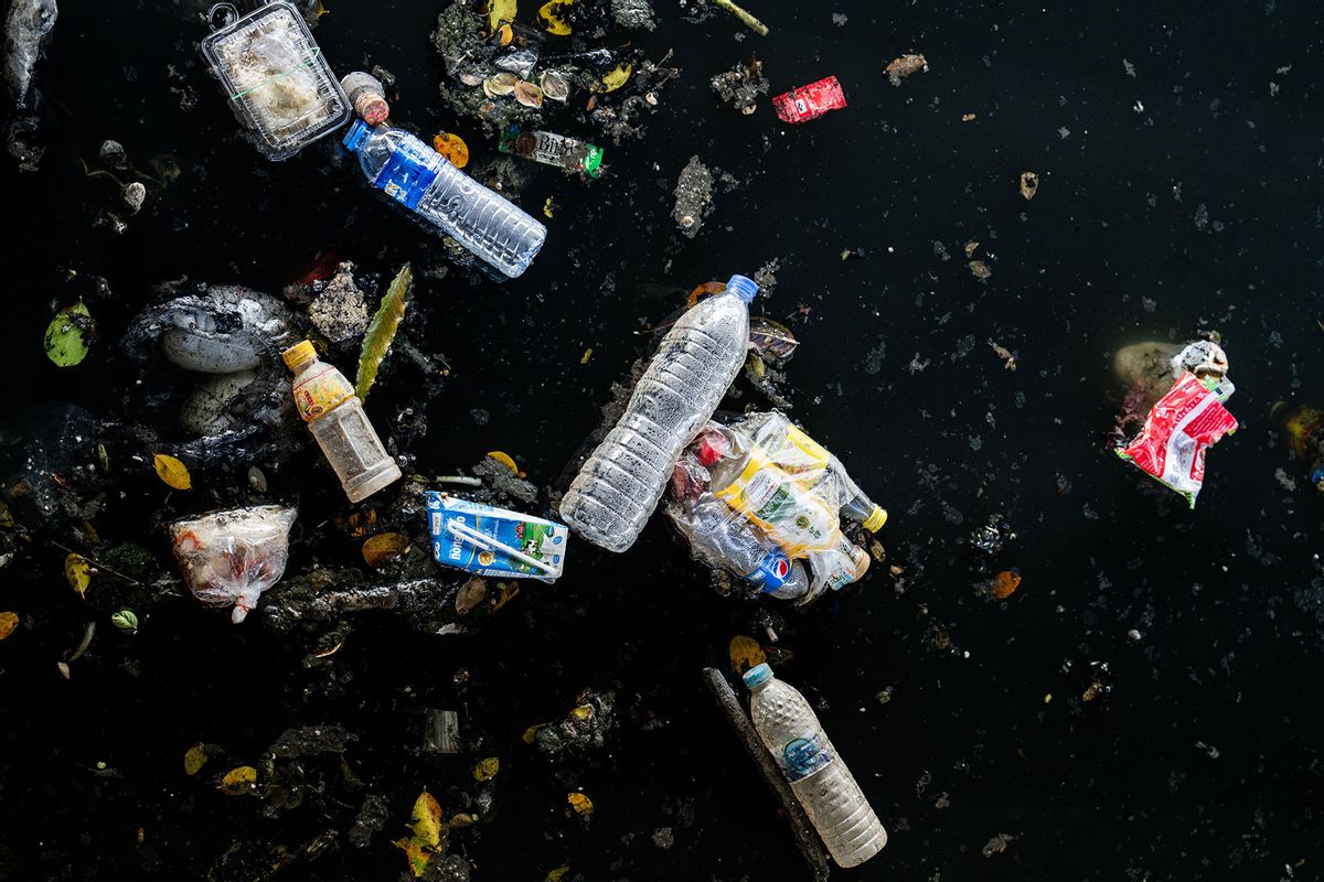 Plastic bottles and other single-use plastic waste are seen floating in Khlong Toey canal. (Matt Hunt/SOPA Images/LightRocket via Getty Images)