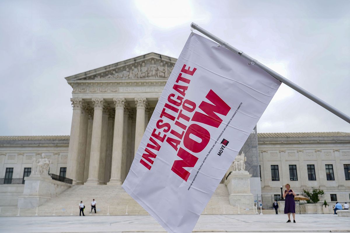 A flag is waved an event at the Supreme Court of the United States with MoveOn and progressive organizations whose members are demanding an investigation into Justice Alito on June 05, 2024 in Washington, DC. (Leigh Vogel/Getty Images for MoveOn)